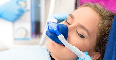 Female patient relaxing with nasal mask for nitrous oxide sedation