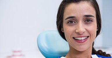 Close up of woman sitting in dental chair smiling