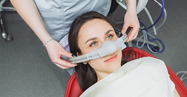 Female patient having nasal mask placed for sedation dentistry in Odessa, TX